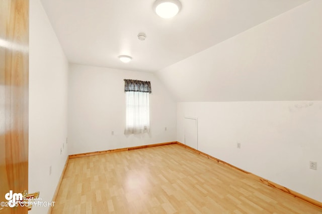 29425 Fools Gold St, Soldotna, AK 99669 - additional living space with light wood-style flooring, vaulted ceiling, and baseboards