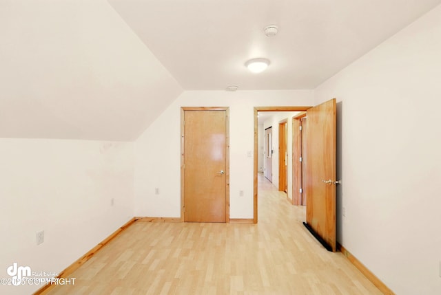 29425 Fools Gold St, Soldotna, AK 99669 - additional living space with light wood-style floors, baseboards, and vaulted ceiling