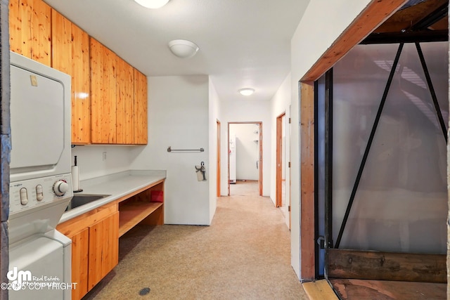 29425 Fools Gold St, Soldotna, AK 99669 - clothes washing area with stacked washer and clothes dryer and light carpet