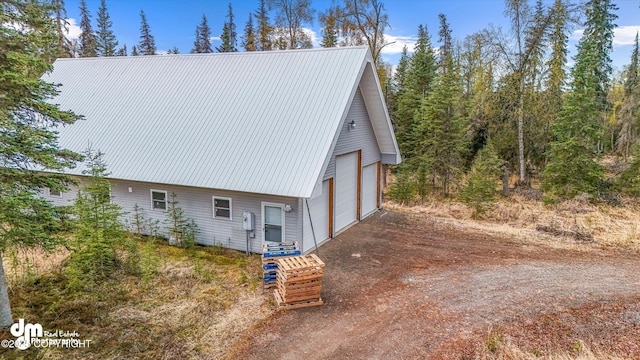29425 Fools Gold St, Soldotna, AK 99669 - view of side of home with a garage and metal roof