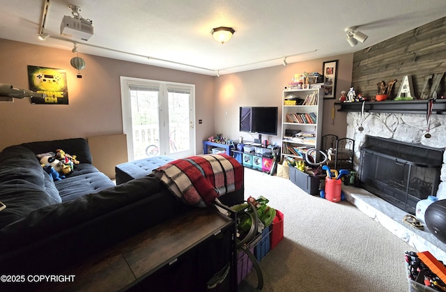 1902 Swetmann Ave, Seward, AK 99664 - carpeted living area featuring rail lighting and a fireplace