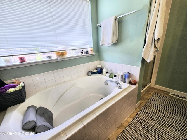 1902 Swetmann Ave, Seward, AK 99664 - full bath featuring tile patterned flooring, visible vents, a garden tub, and a stall shower