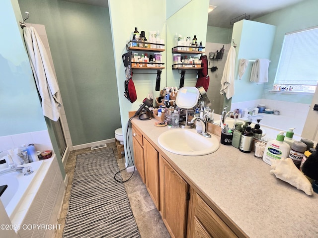 1902 Swetmann Ave, Seward, AK 99664 - bathroom with visible vents, a garden tub, vanity, toilet, and a stall shower