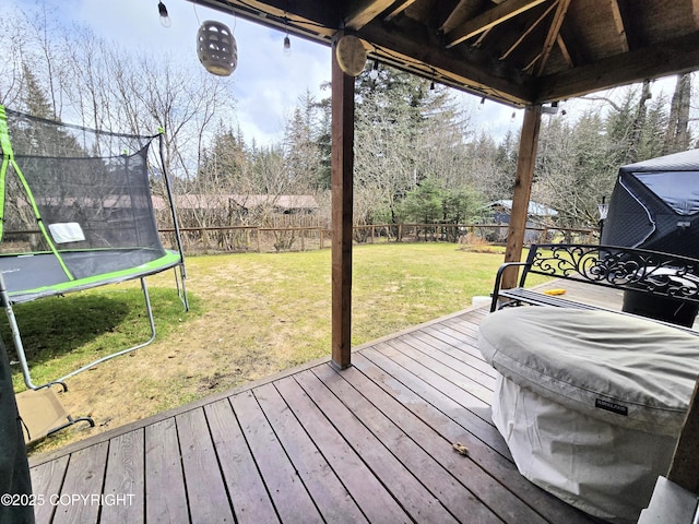 1902 Swetmann Ave, Seward, AK 99664 - wooden deck featuring a lawn, a fenced backyard, and a trampoline