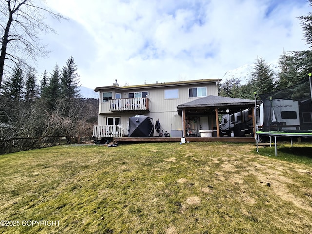 1902 Swetmann Ave, Seward, AK 99664 - back of property with a trampoline, a yard, a balcony, and a deck
