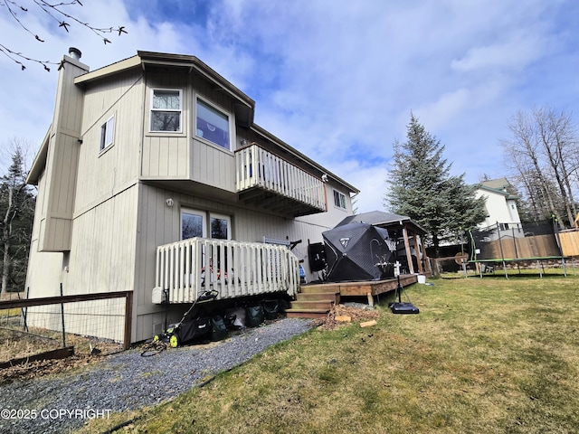 1902 Swetmann Ave, Seward, AK 99664 - exterior space featuring a trampoline, a wooden deck, a chimney, a balcony, and a yard