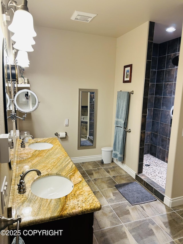 5789 S Hanson Loop, Wasilla, AK 99654 - full bath featuring visible vents, tiled shower, double vanity, and a sink
