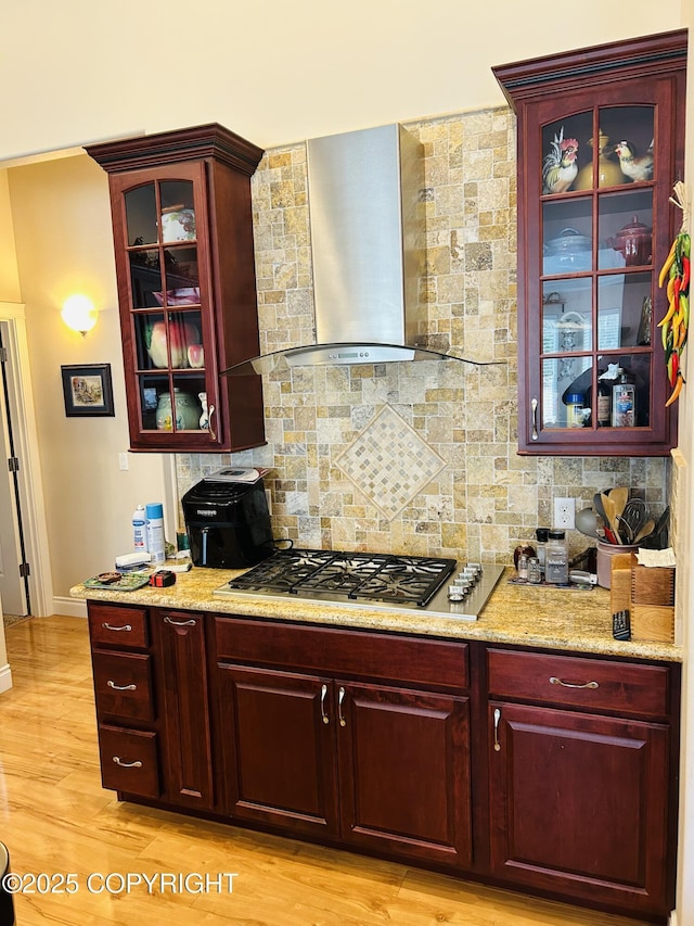 5789 S Hanson Loop, Wasilla, AK 99654 - kitchen with stainless steel gas cooktop, dark brown cabinets, wall chimney exhaust hood, and decorative backsplash