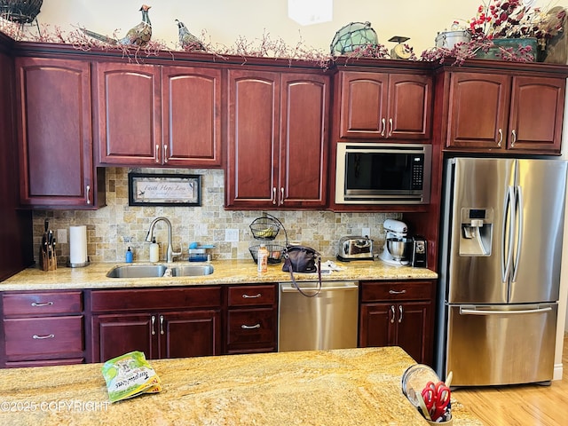 5789 S Hanson Loop, Wasilla, AK 99654 - kitchen with tasteful backsplash, light stone counters, stainless steel appliances, dark brown cabinets, and a sink