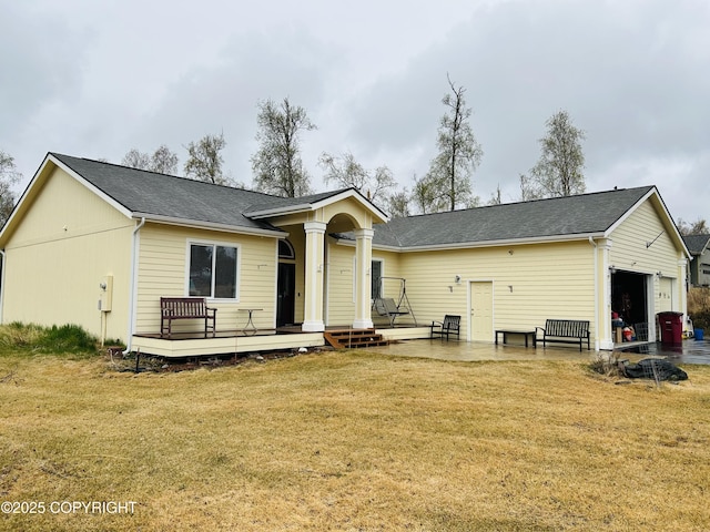 5789 S Hanson Loop, Wasilla, AK 99654 - rear view of house with roof with shingles, a yard, an attached garage, and a wooden deck