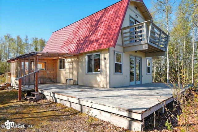 8266 S Big Lake Rd, Big Lake, AK 99652 - back of house featuring metal roof, a balcony, a deck, and a pergola