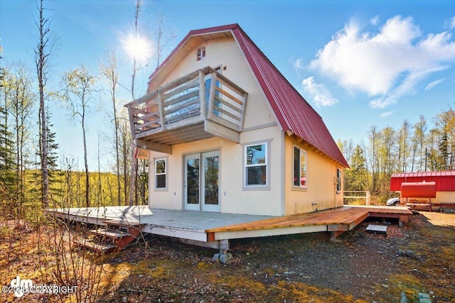 8266 S Big Lake Rd, Big Lake, AK 99652 - back of house with a balcony, metal roof, and a wooden deck