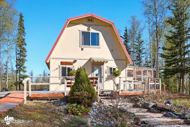 8266 S Big Lake Rd, Big Lake, AK 99652 - view of front facade featuring a deck and a gambrel roof