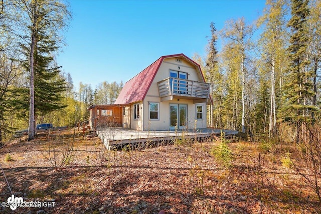8266 S Big Lake Rd, Big Lake, AK 99652 - rear view of property with a balcony, a gambrel roof, and a wooden deck