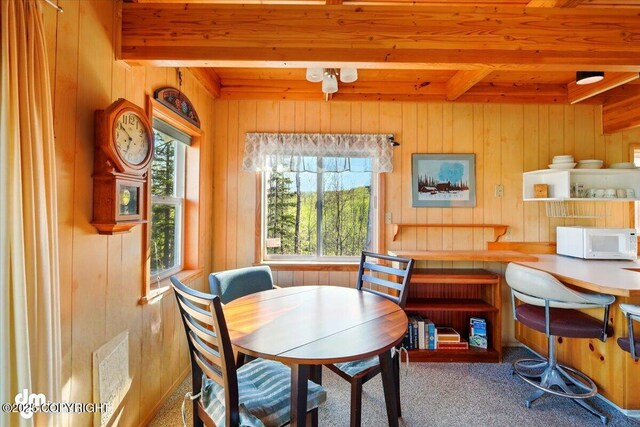 8266 S Big Lake Rd, Big Lake, AK 99652 - carpeted dining area featuring wood ceiling, beam ceiling, and wooden walls