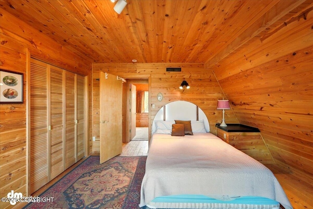 8266 S Big Lake Rd, Big Lake, AK 99652 - bedroom with wood walls, wood ceiling, a closet, and wood finished floors