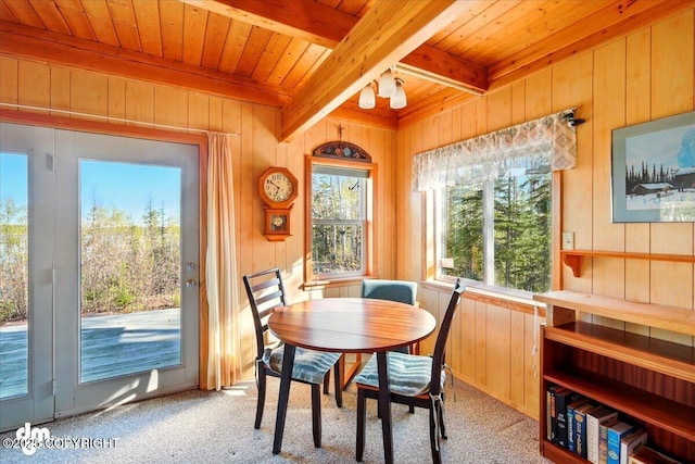 8266 S Big Lake Rd, Big Lake, AK 99652 - dining space with wood ceiling, beamed ceiling, wood walls, and light carpet