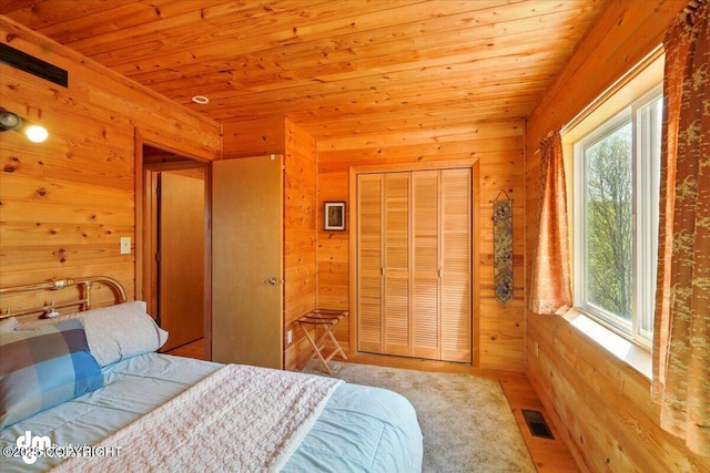 8266 S Big Lake Rd, Big Lake, AK 99652 - bedroom featuring wood ceiling, wood walls, and a closet