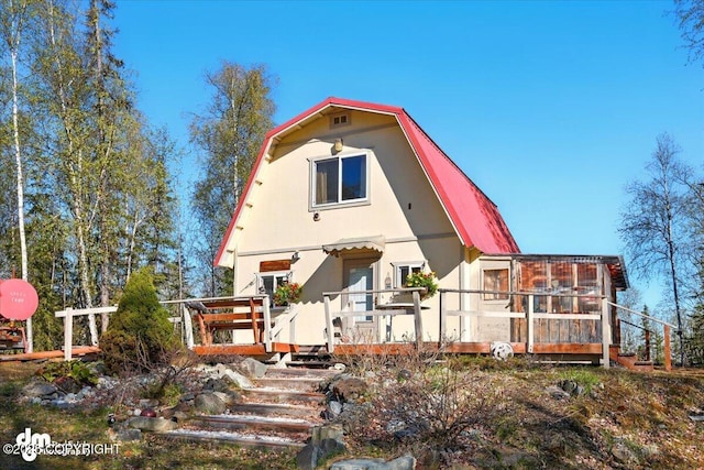 8266 S Big Lake Rd, Big Lake, AK 99652 - view of front of home with a gambrel roof and a wooden deck