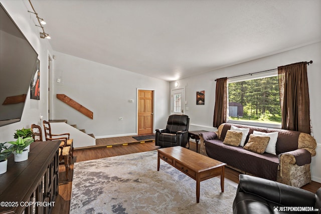 6700 Omalley Rd, Anchorage, AK 99507 - living area featuring stairs, wood finished floors, and baseboards