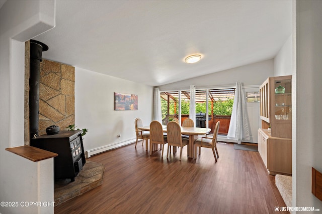 6700 Omalley Rd, Anchorage, AK 99507 - dining room featuring a wood stove, baseboard heating, vaulted ceiling, and dark wood-type flooring