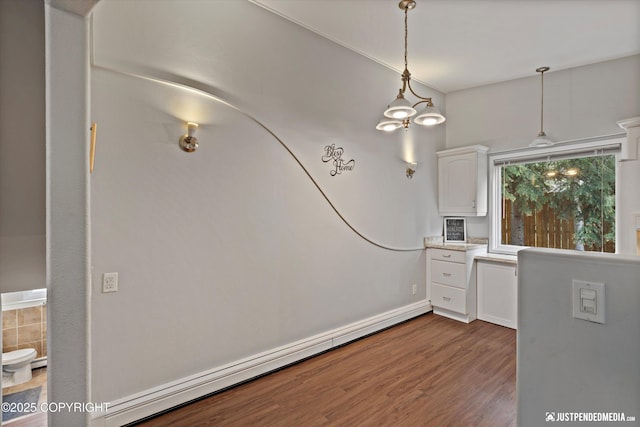 6700 Omalley Rd, Anchorage, AK 99507 - unfurnished dining area with wood finished floors and a baseboard radiator