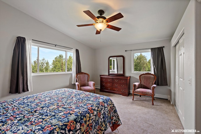 6700 Omalley Rd, Anchorage, AK 99507 - carpeted bedroom featuring multiple windows, a closet, a baseboard radiator, and ceiling fan