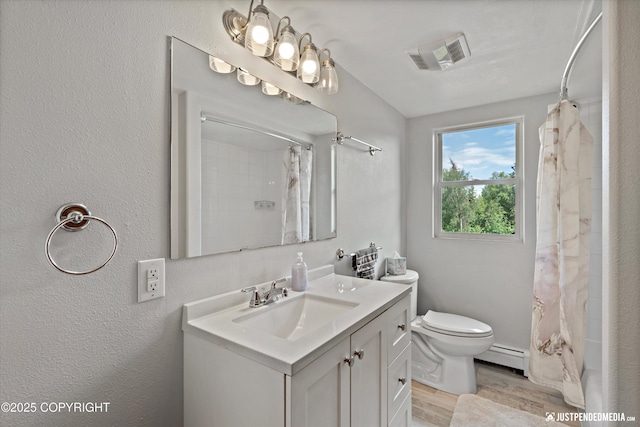 6700 Omalley Rd, Anchorage, AK 99507 - bathroom with a baseboard heating unit, vanity, wood finished floors, and toilet