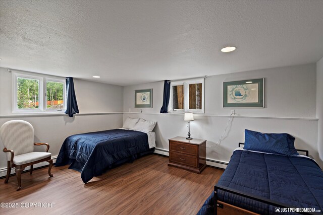 6700 Omalley Rd, Anchorage, AK 99507 - bedroom with a textured ceiling, wood finished floors, recessed lighting, and baseboard heating