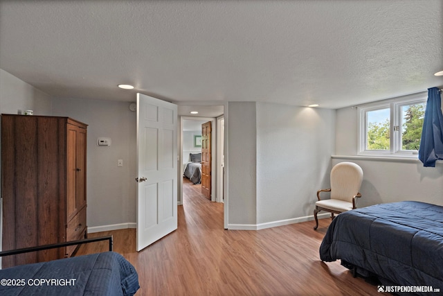 6700 Omalley Rd, Anchorage, AK 99507 - bedroom featuring baseboards, a textured ceiling, light wood finished floors, and recessed lighting