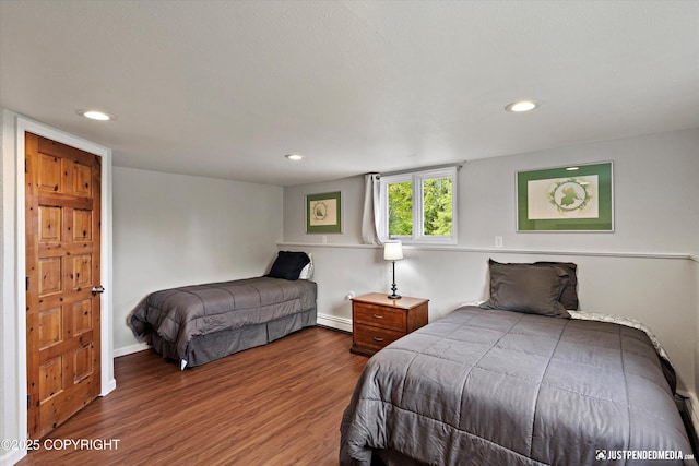 6700 Omalley Rd, Anchorage, AK 99507 - bedroom with a baseboard heating unit, wood finished floors, baseboards, and recessed lighting