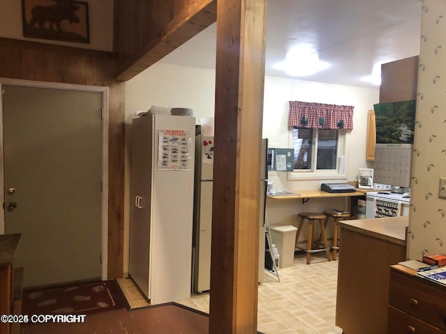 35290 Fisherman Rd, Soldotna, AK 99669 - kitchen with light countertops, freestanding refrigerator, and brick floor