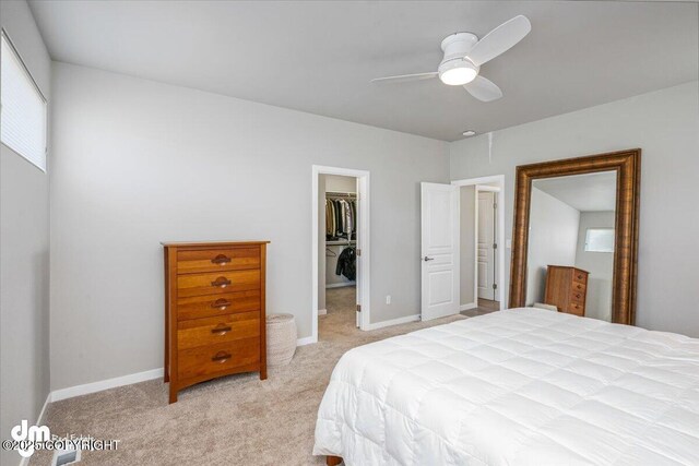 3412 Red Rock Ct, Anchorage, AK 99502 - bedroom featuring a closet, light carpet, baseboards, a walk in closet, and ceiling fan