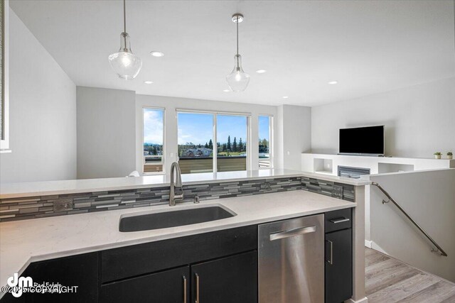 3412 Red Rock Ct, Anchorage, AK 99502 - kitchen featuring a sink, dark cabinetry, stainless steel dishwasher, and open floor plan