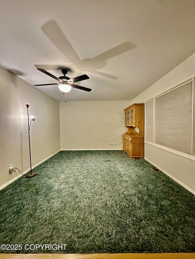 33434 Nash Rd, Seward, AK 99664 - empty room featuring dark carpet, a ceiling fan, and baseboards