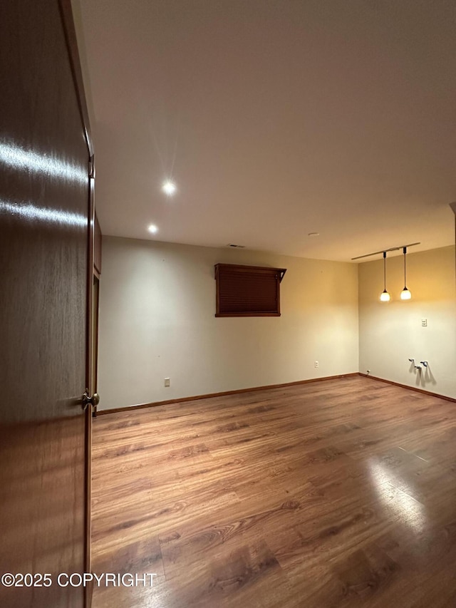 33434 Nash Rd, Seward, AK 99664 - unfurnished room with baseboards and wood finished floors