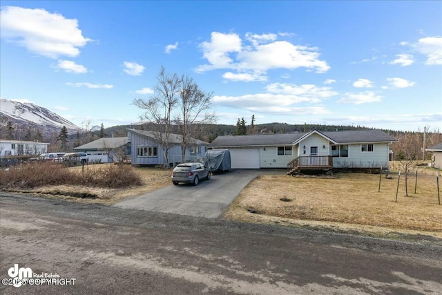 8000 Cox Dr, Anchorage, AK 99516 - ranch-style home featuring aphalt driveway, a front lawn, and a garage