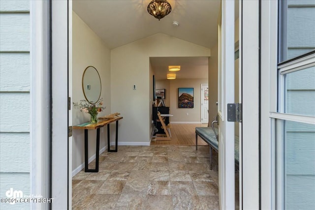 8000 Cox Dr, Anchorage, AK 99516 - entrance foyer with stone finish floor, vaulted ceiling, and baseboards