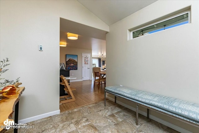 8000 Cox Dr, Anchorage, AK 99516 - corridor with a healthy amount of sunlight, high vaulted ceiling, and baseboards