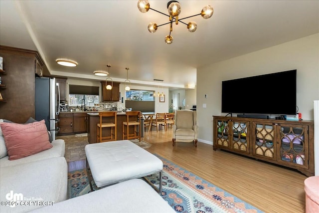 8000 Cox Dr, Anchorage, AK 99516 - living area with a notable chandelier, dark wood finished floors, and baseboards