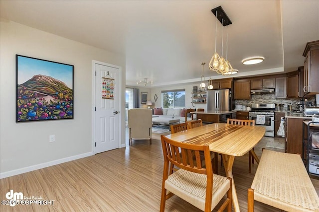 8000 Cox Dr, Anchorage, AK 99516 - dining room featuring light wood finished floors, a notable chandelier, and baseboards