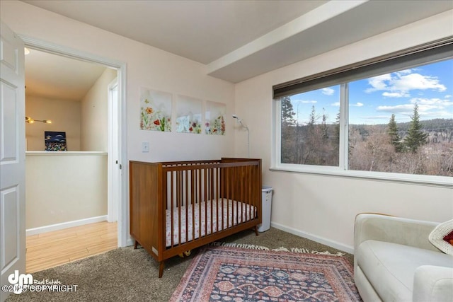 8000 Cox Dr, Anchorage, AK 99516 - carpeted bedroom with baseboards and a nursery area