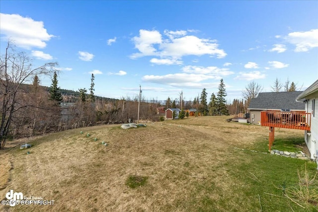 8000 Cox Dr, Anchorage, AK 99516 - view of yard with a storage unit, a wooden deck, and an outbuilding