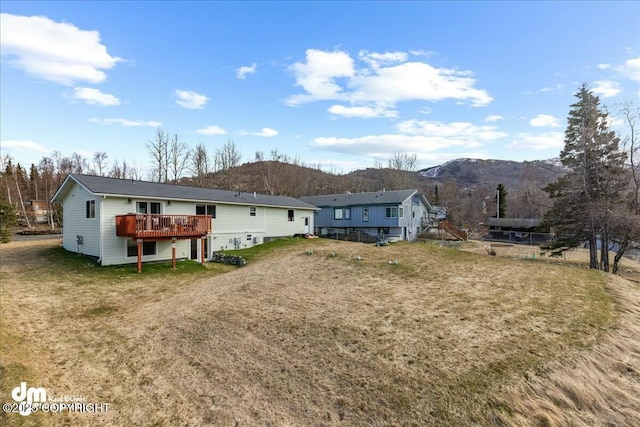 8000 Cox Dr, Anchorage, AK 99516 - back of house with a deck with mountain view and a yard