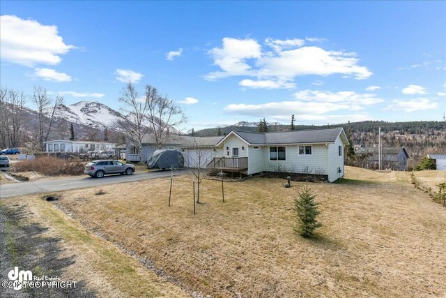 8000 Cox Dr, Anchorage, AK 99516 - view of front of house featuring a mountain view, aphalt driveway, and a front lawn
