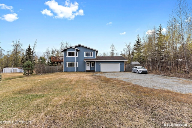 view of front facade featuring a garage, a front lawn, fence, and gravel driveway