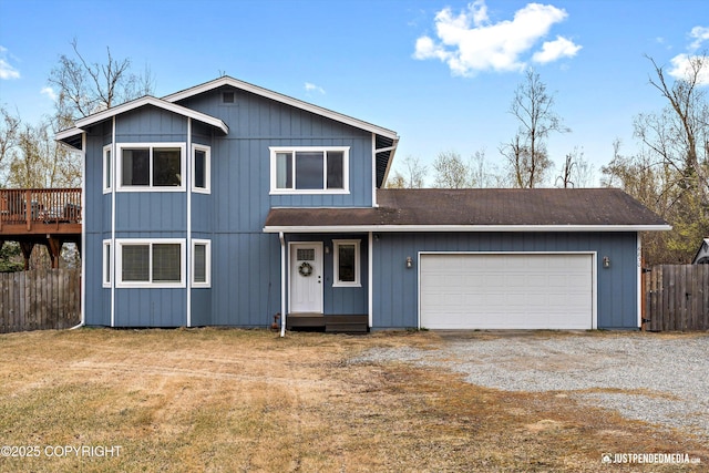 view of front of home with driveway, roof with shingles, a garage, fence, and a front lawn