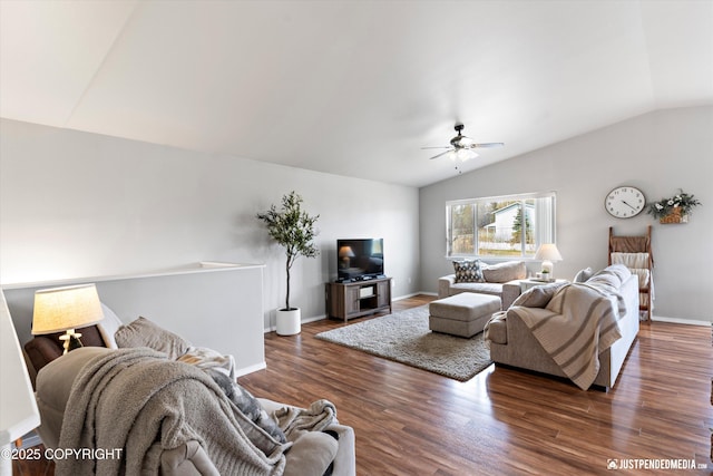 living area featuring baseboards, ceiling fan, wood finished floors, and vaulted ceiling