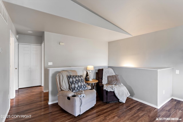 sitting room featuring baseboards, visible vents, wood finished floors, and lofted ceiling
