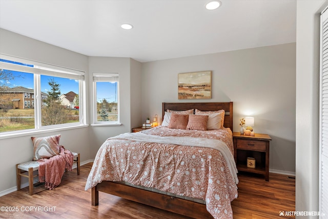 bedroom featuring baseboards, recessed lighting, and wood finished floors